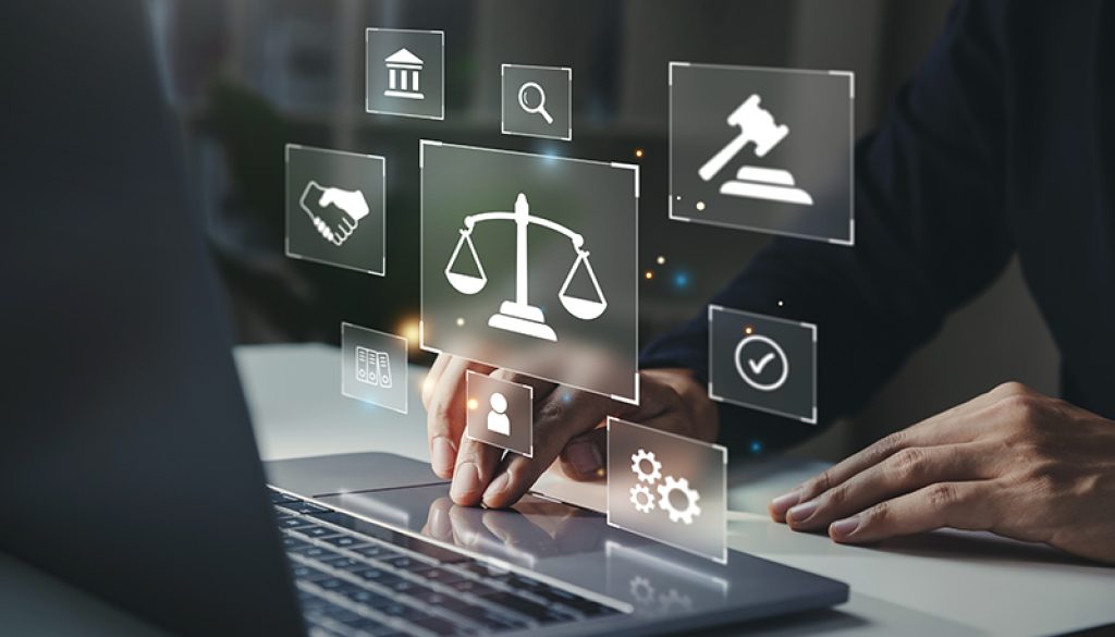 Hand of human with legal services icon on laptop screen.